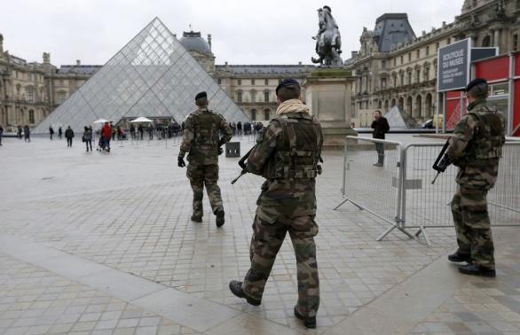 French soldiers patrol near the Louvre Museum in Paris as part of the highest level of "Vigipirate" security plan, the day after a shooting at the Paris offices of Charlie Hebdo