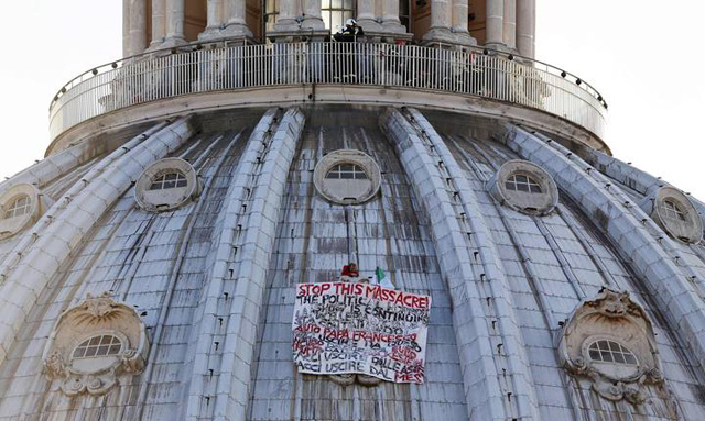Italian businessman Di Finizio displays a banner to protest against austerity measures, on the dome of St. Peter's Basilica at the Vatican