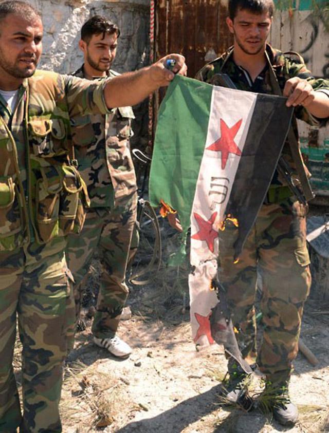 Syrian government troops burn the flag a