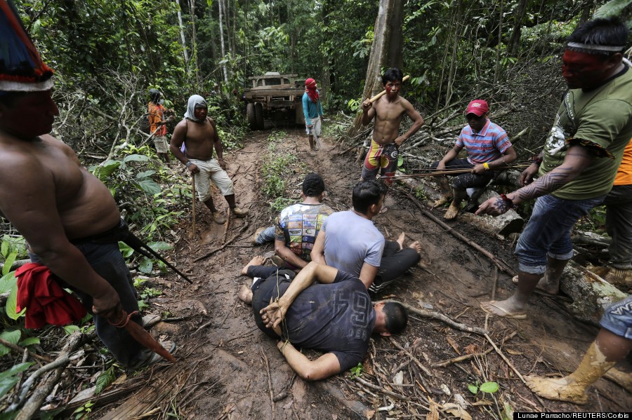 Ka'apor Indian warriors tie up loggers during a jungle expedition in the Alto Turiacu Indian territory