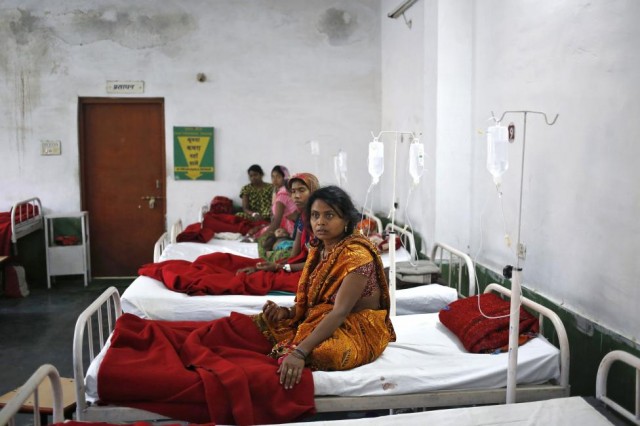 Women, who underwent a sterilization surgery at a government mass sterilisation "camp", lie in hospital beds for treatment at CIMS hospital in Bilaspur