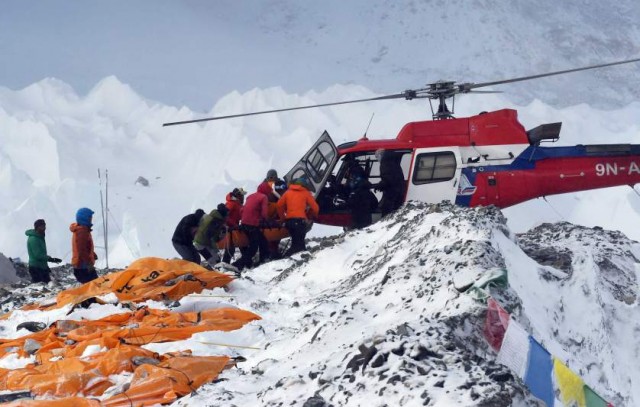 TOPSHOTS An injured person is loaded onto a rescue helicopter at Everest Base Camp on April 26, 2015, a day after an avalanche triggered by an earthquake devastated the camp. Rescuers in Nepal are searching frantically for survivors of a huge quake on April 25, that killed nearly 2,000, digging through rubble in the devastated capital Kathmandu and airlifting victims of an avalanche at Everest base Camp.  The bodies of those who perished lie under orange tents.  AFP PHOTO/ROBERTO SCHMIDTROBERTO SCHMIDT/AFP/Getty Images