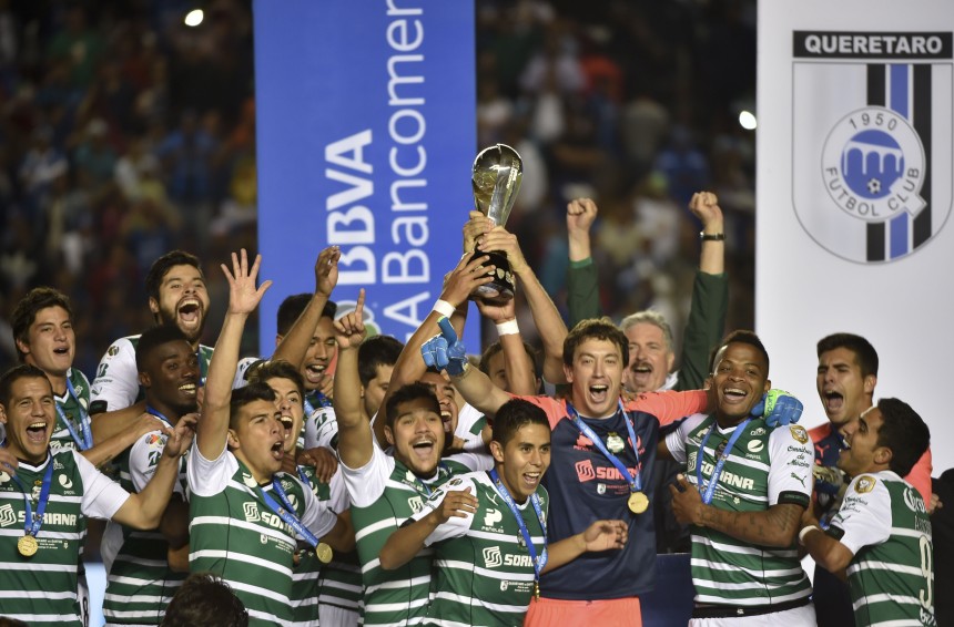 Santos's footballers celebrate with the trophy after their Clausura tournament football final match victory over  Queretaro at the Corregidora stadium in Queretaro, Mexico on May 31, 2015. AFP PHOTO / Yuri CORTEZ        (Photo credit should read YURI CORTEZ/AFP/Getty Images)