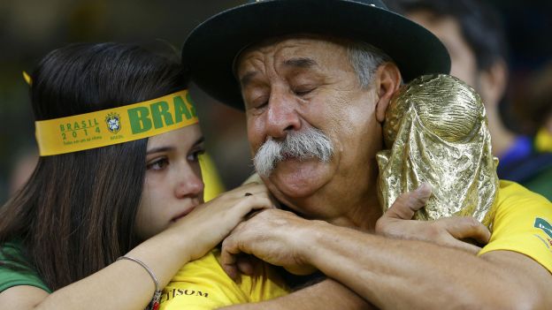 Brazilian fans react to their team's loss at the end of their 2014 World Cup semi-finals against Germany at the Mineirao stadium in Belo Horizonte July 8, 2014. REUTERS/Damir Sagolj (BRAZIL  - Tags: SOCCER SPORT WORLD CUP TPX IMAGES OF THE DAY)