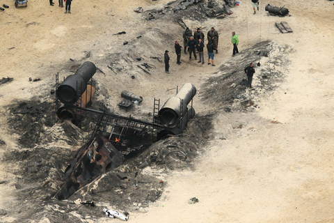EXCLUSIVE: A burnt out ship and dead Storm Troopers can be seen during filming of Star Wars Rogue One.