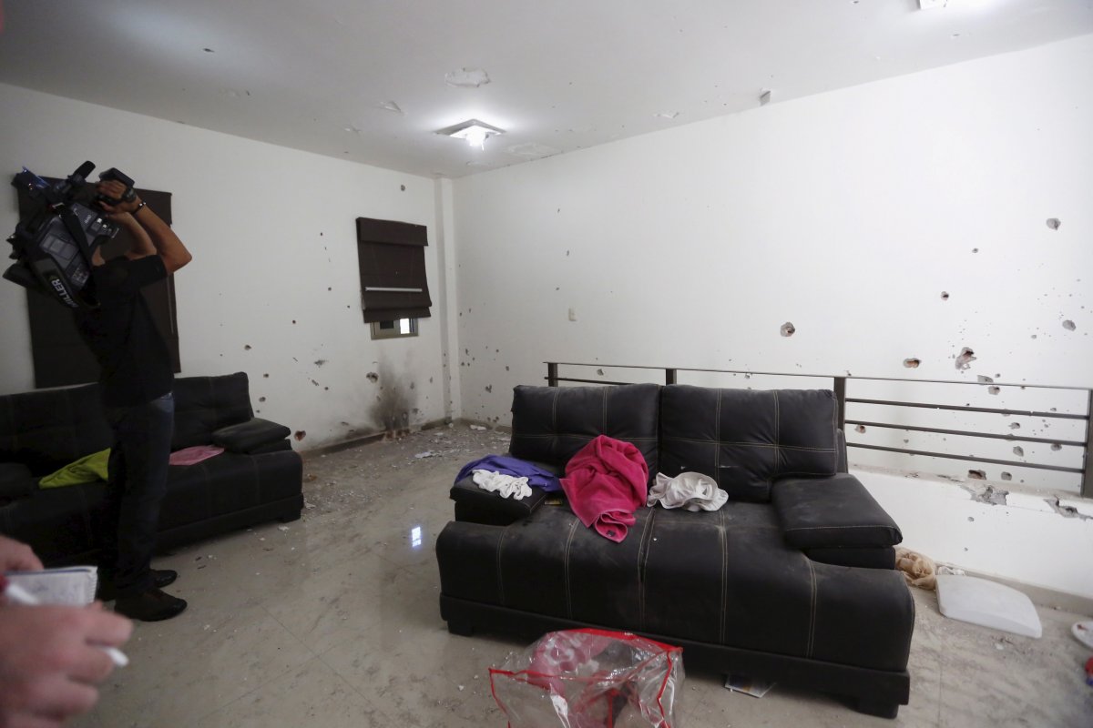 bullet-holes-are-seen-across-the-living-room-walls