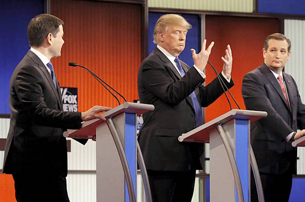 Republican U.S. presidential candidate Donald Trump shows off the size of his hands as rivals Marco Rubio (L) and Ted Cruz (R) look on at the start of the U.S. Republican presidential candidates debate in Detroit, Michigan, March 3, 2016. REUTERS/Jim Young  - RTS97MX