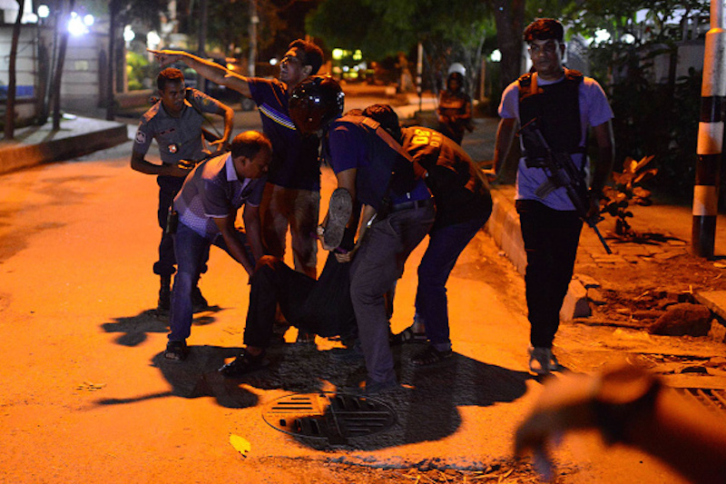 DHAKA, BANGLADESH - JULY 2: An injured man receieves help after an attack at a restaurant in the early hours of July 2, 2016 in Dhaka, Bangladesh. Gunmen have taken at least 20 foreigners hostage at a restaurant in the diplomatic area of Dhaka, the capital of Bangladesh. So-called Islamic State have claimed reponsibility for the attack, which has reportedly left at least 2 police officers dead and many more people injured. (Photo by Mahmud Hossain Opu/Getty Images)