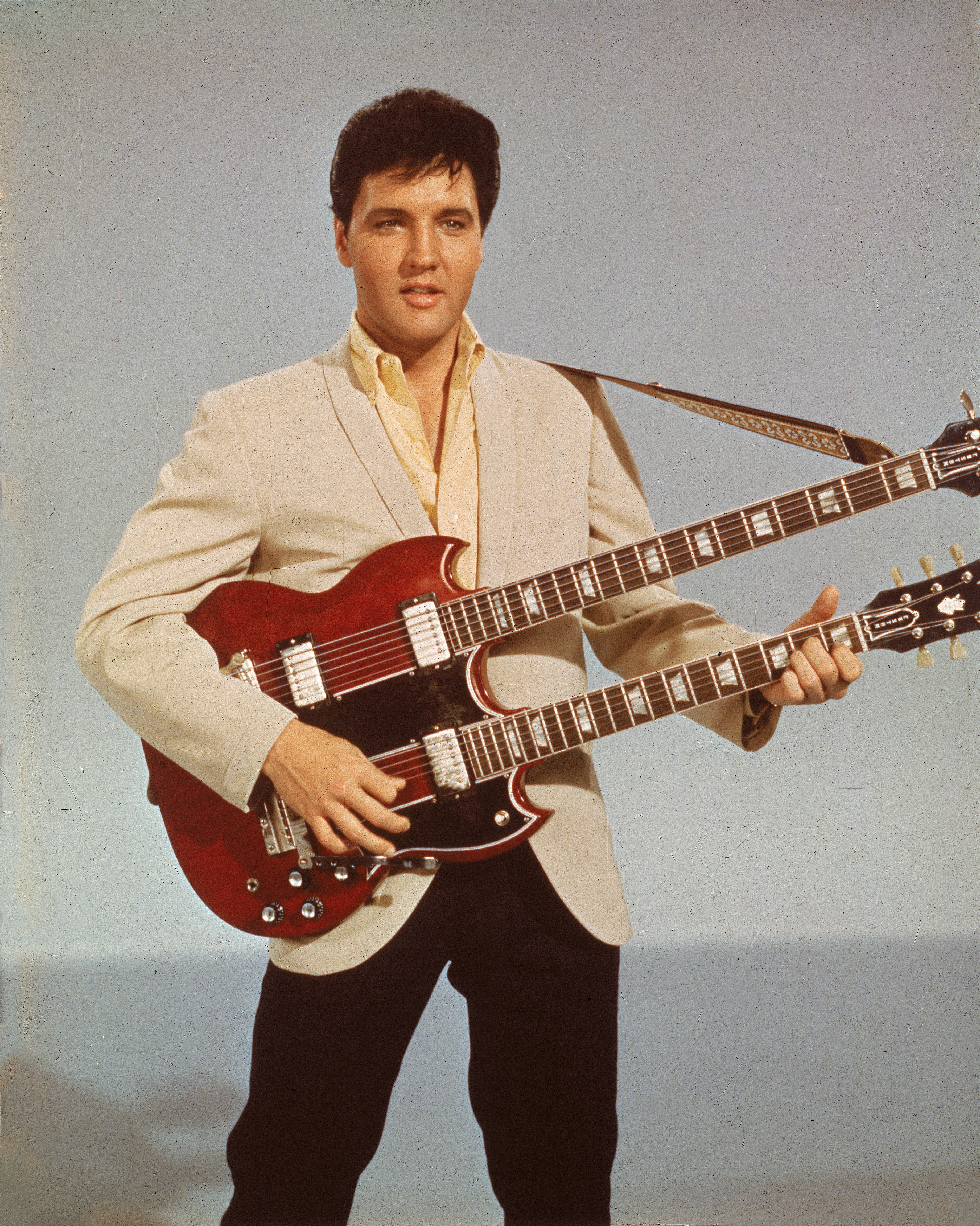 Portrait of American singer and actor Elvis Presley (1935 - 1977) as he holds a twelve string guitar, mid 1950s . (Photo by Hulton Archive/Getty Images)