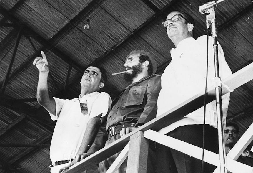 1st August 1962: Left to right, Jose Llanusa, director of the Institute of Sports, Physical Education and Recreation, Prime Minister Fidel Castro and President of the Republic Osvaldo Dorticos Torrado. They are watching a performance st the gymnastic festival in Havana, Cuba, in which 80,000 people participated. (Photo by Keystone/Getty Images)