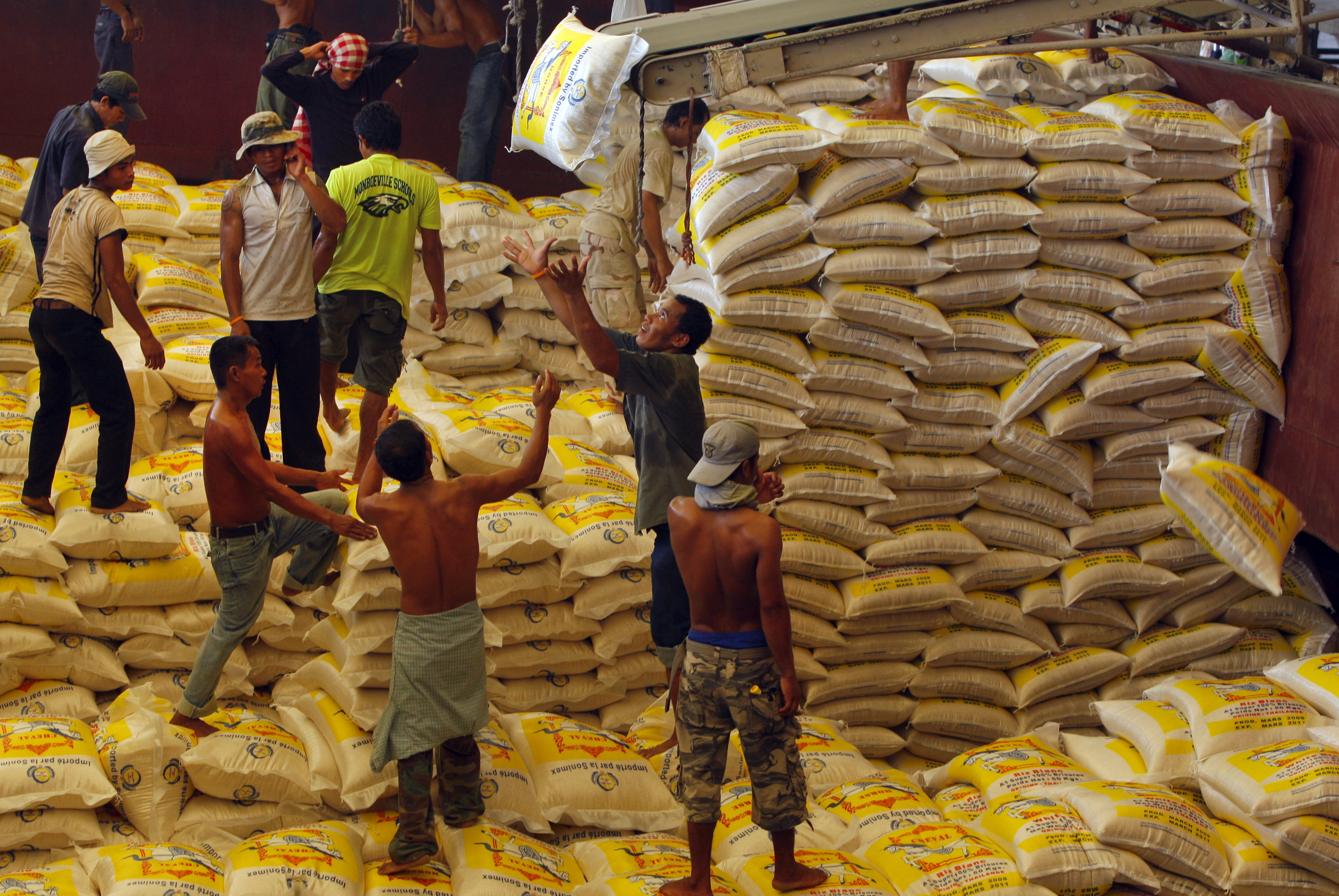 BANG PAKONG, THAILAND - MARCH 11: Workers load a ship with 1000 tons of rice bound for Africa at the Asia Golden Rice export company on March 11, 2009 in Bang Pakong, Thailand. The rice export company is getting a lot of orders from Africa and U.A.E so is surviving in the financial crisis. Exports in Thailand have taken a hit from the global financial meltdown with Thailand's rice exports falling 37.74 percent year-on year in terms of volume according to the Commerce ministry. The country shipped only 628,792 tons of rice valued at USD331 million compared with 1.01 million tons last year valued at USD421 million and overall the country's exports for 2009 are expected to decline 10 percent. Unemployment is another major problem as the new school graduates start looking for work this summer and if layoffs continue the number of jobless will be as high as 1.3 million. (Photo Paula Bronstein/Getty Images)