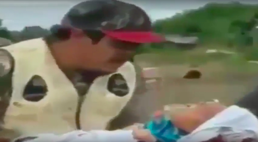 Un hombre mete a un bebé en un animal muerto
