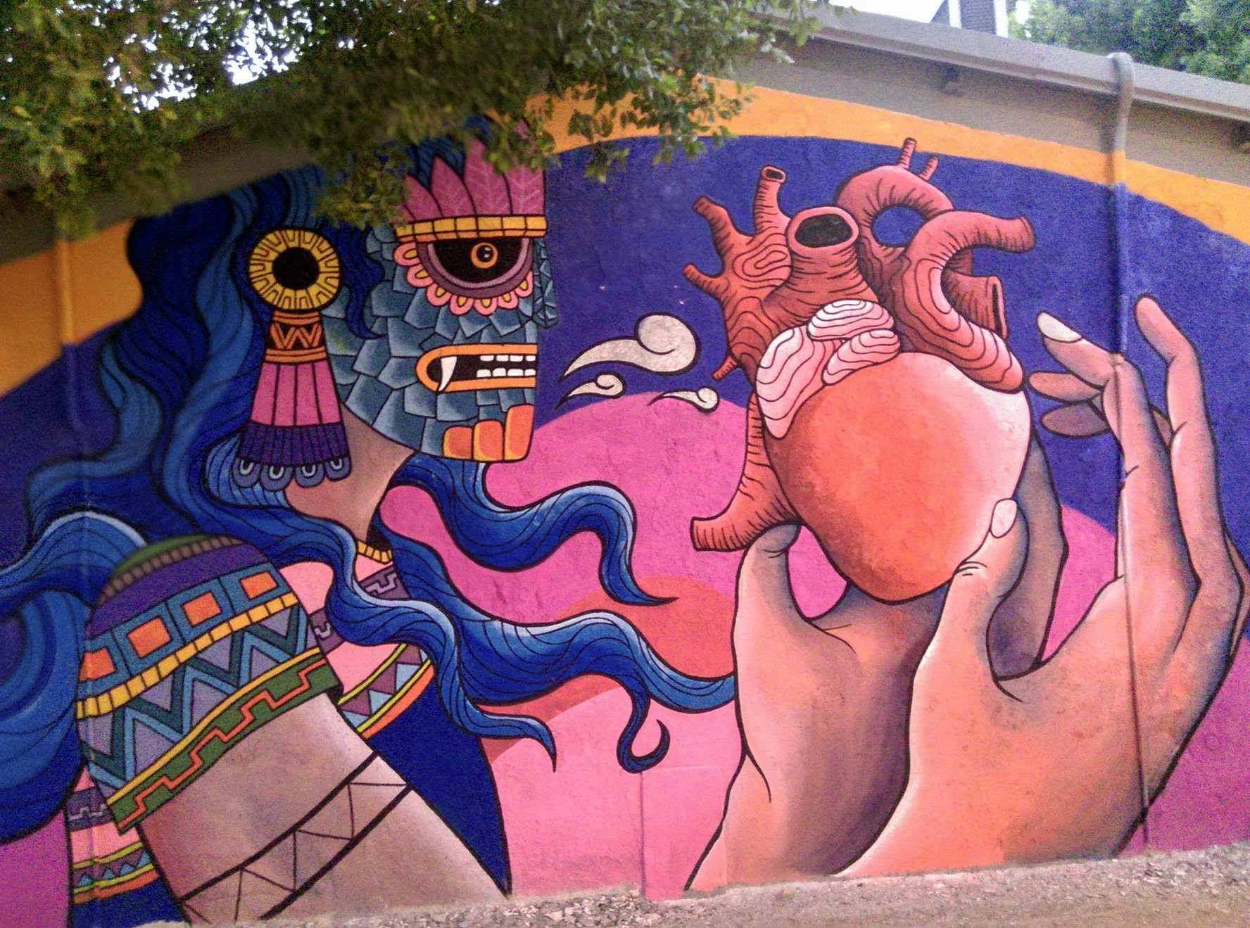 Graffiti de dios prehispánico con corazón humano