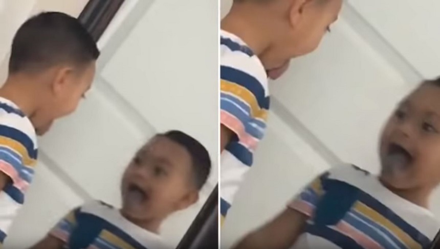 El niño y su extraño reflejo en un espejo