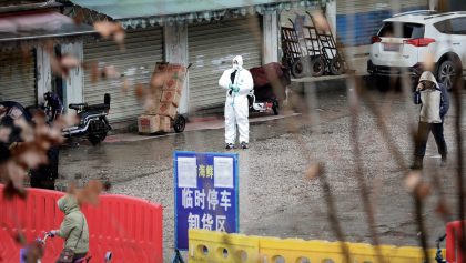 A worker in a protective suit is seen at the closed seafood market in Wuhan