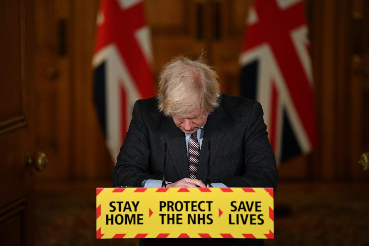 Britain's Prime Minister Boris Johnson looks down at the podium as he attends a virtual news conference on the COVID-19 pandemic inside 10 Downing Street in London, Britain January 26, 2021.