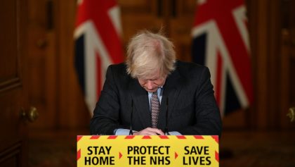 Britain's Prime Minister Boris Johnson looks down at the podium as he attends a virtual news conference on the COVID-19 pandemic inside 10 Downing Street in London, Britain January 26, 2021.