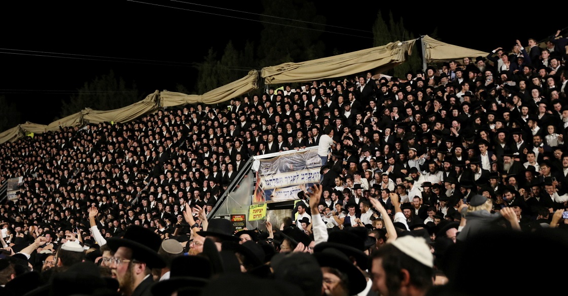 Jewish worshippers sing and dance as they stand on tribunes at the Lag B'Omer event in Mount Meron, northern Israel, April 29, 2021. 