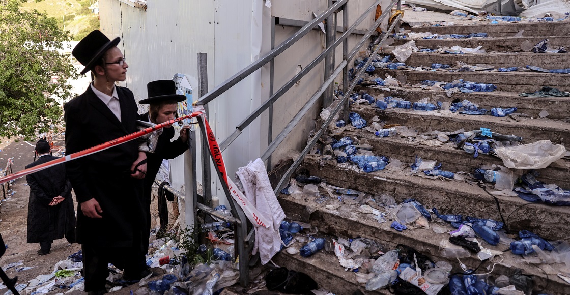 Ultra Orthodox Jews look at stairs with waste on it in Mount Meron, northern Israel, where fatalities were reported among the thousands of ultra-Orthodox Jews gathered at the tomb of a 2nd-century sage for annual commemorations that include all-night prayer and dance, April 30, 2021.