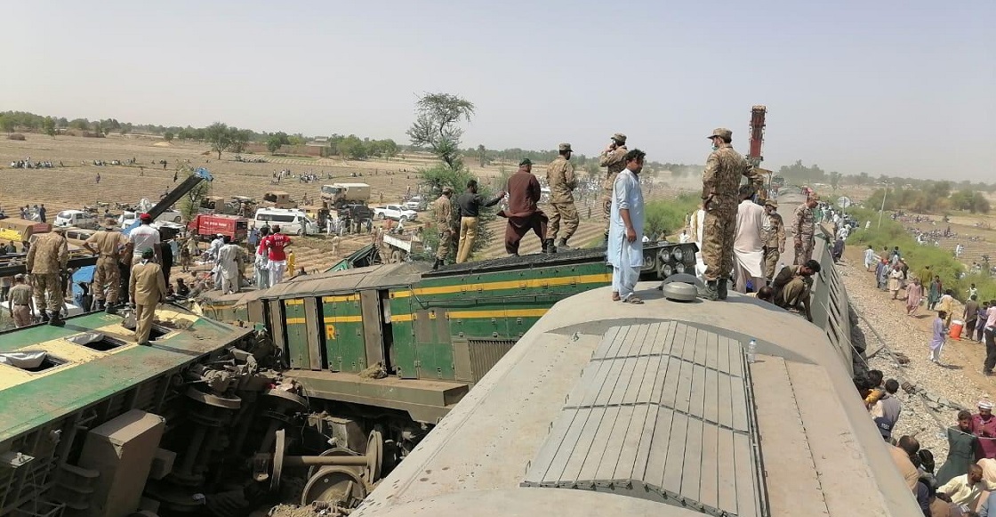 Paramilitary soldiers and rescue workers gather at the site following a collision between two trains in Ghotki, Pakistan June 7, 2021. Inter-Services Public Relations (ISPR)/ Handout via