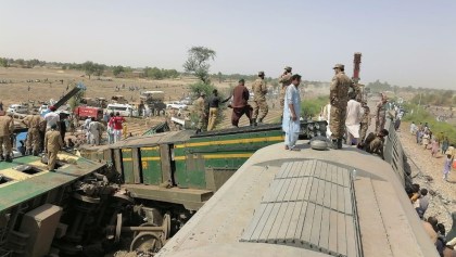 Paramilitary soldiers and rescue workers gather at the site following a collision between two trains in Ghotki, Pakistan June 7, 2021. Inter-Services Public Relations (ISPR)/ Handout via