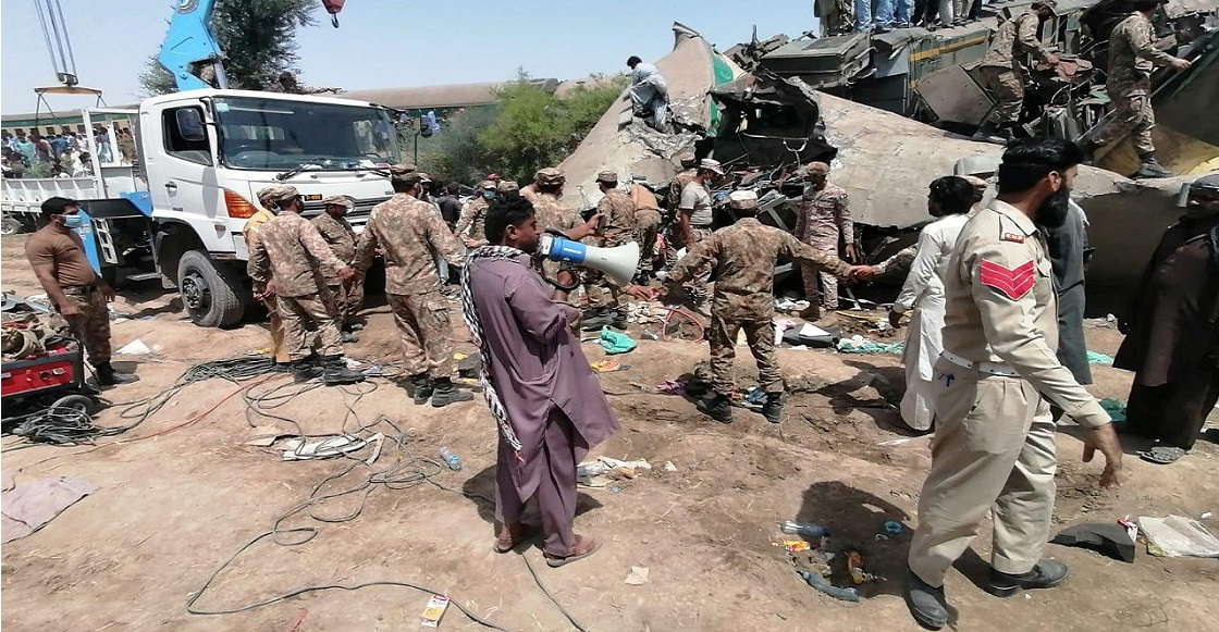 Paramilitary soldiers and rescue workers gather at the site following a collision between two trains in Ghotki, Pakistan June 7, 2021. Inter-Services Public Relations (ISPR)/ Handout via 
