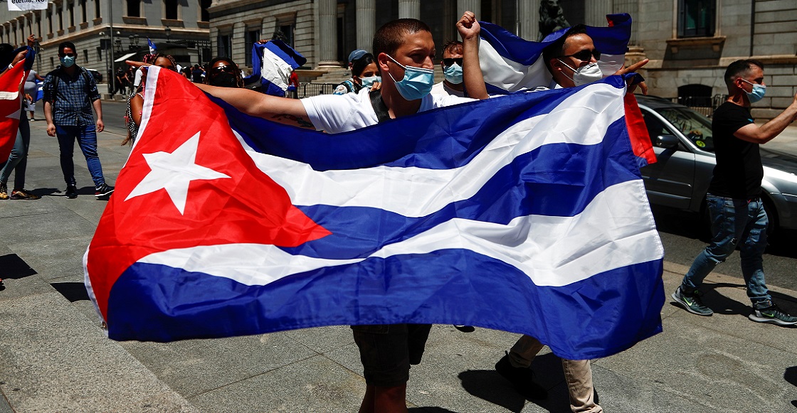 A man holds a Cuban flag during a demonstration, called for by Cuban dissident group Prisoners Defenders, in support of anti-government protests in Cuba, in front of the Spanish parliament in Madrid, Spain, July 12, 2021. 