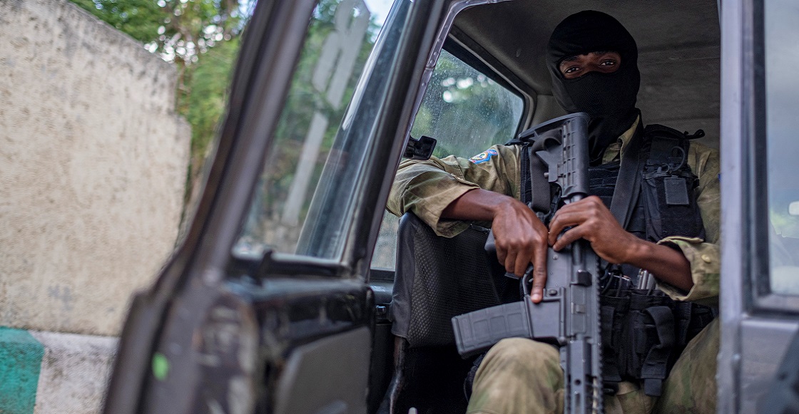A Haitian police officer guards outside the residence of late President Jovenel Moise while FBI agents inspect the property in Port-au-Prince, Haiti, July 15, 2021.