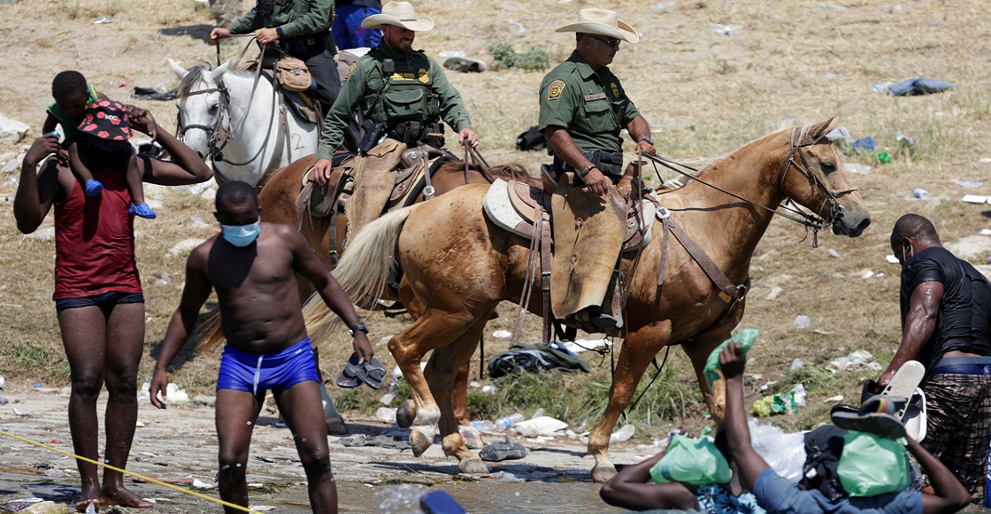 U.S. Border Patrol agents ride horses on the banks of the Rio Grande river, border between Ciudad Acuna, Mexico and Del Rio, Texas, U.S., as migrants seeking refuge into the United States cross the river, in Ciudad Acuna, Mexico September 20, 2021.
