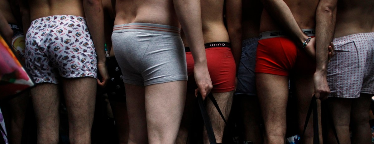 People in their underwear wait to get clothes for free outside a clothing store in Madrid January 2, 2011. A clothing brand marked the start of sales in Madrid by offering the first 100 customers clothes for free as long as they showed up in their underwear.