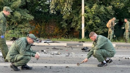Investigators work at the site of a suspected car bomb attack that killed Darya Dugina, daughter of ultra-nationalist Russian ideologue Alexander Dugin, in the Moscow region, Russia August 21, 2022. Investigative Committee of Russia/Handout via