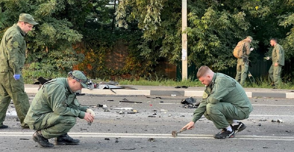 Investigators work at the site of a suspected car bomb attack that killed Darya Dugina, daughter of ultra-nationalist Russian ideologue Alexander Dugin, in the Moscow region, Russia August 21, 2022. Investigative Committee of Russia/Handout via