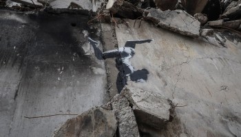 A work of world-renowned graffiti artist Banksy is seen at the wall of destroyed building in the Ukrainian town of Borodianka, which had been occupied by Russia until April and heavily damaged by fighting in the early days of Russian invasion, November 12, 2022.